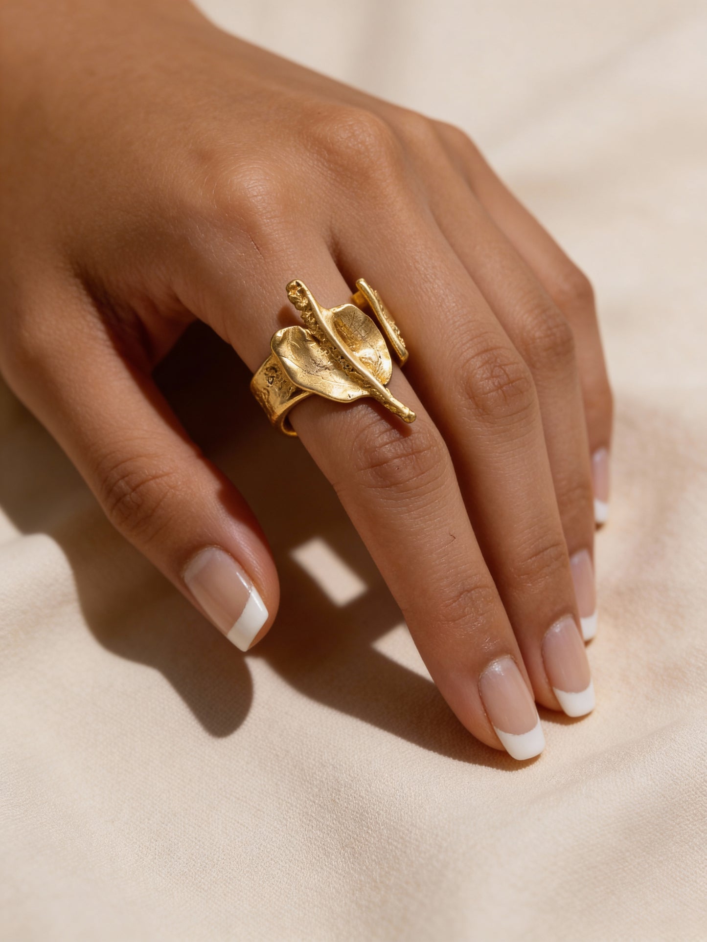 18K gold Gaudi ring on hand, sculpted abstract top with open center