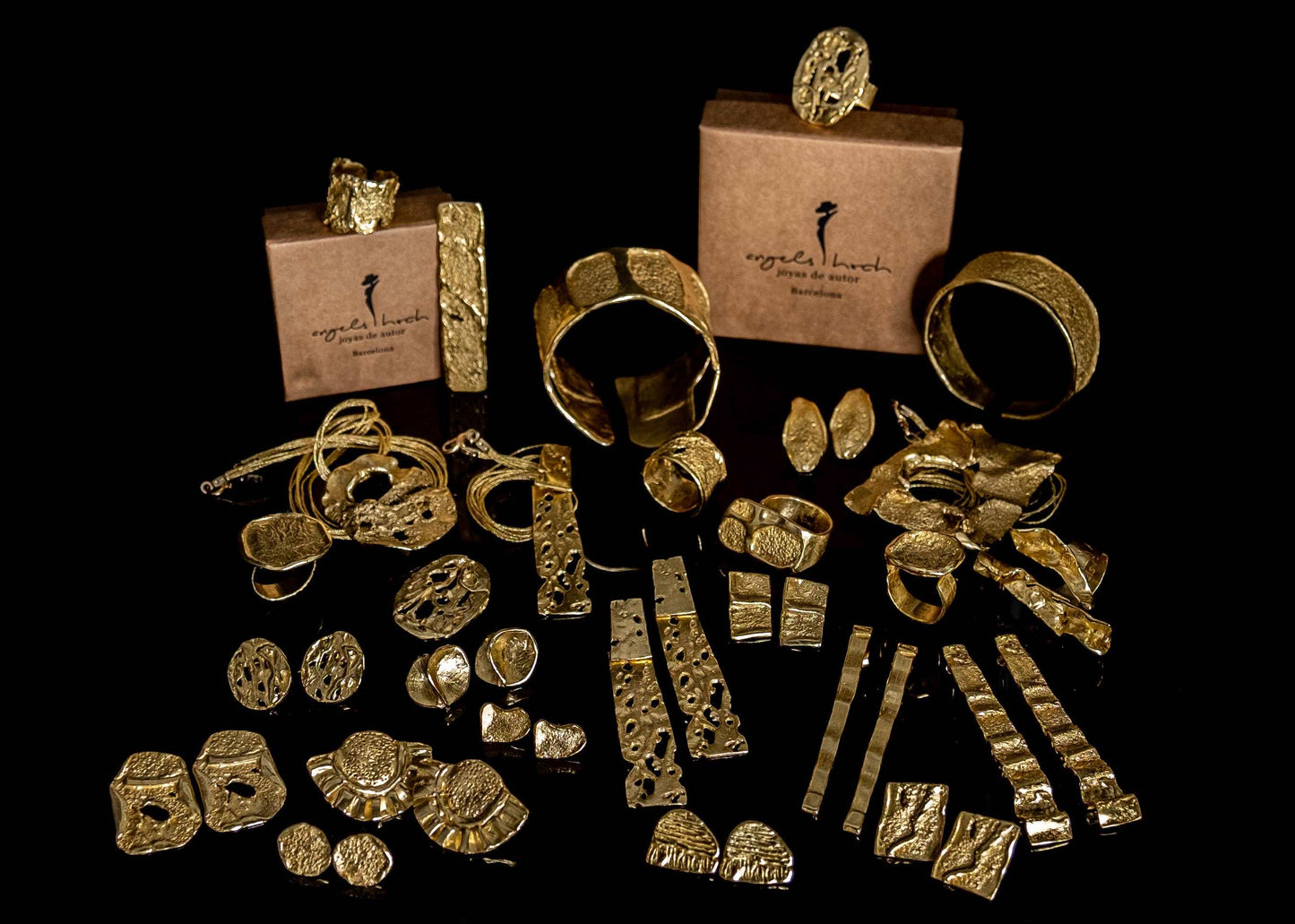 Gold cuff bracelet displayed with matching gold jewelry pieces