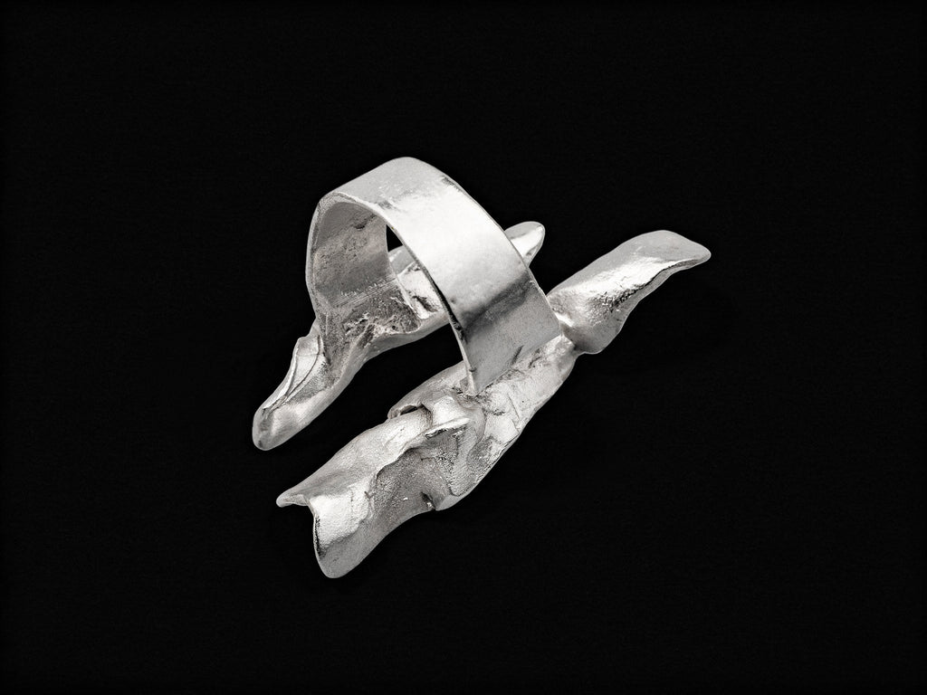 Silver open wave ring with smooth curved band and jagged textured edges.