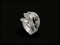 Silver sculpted ring with rough, wave-like textured band and raised top form