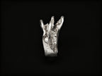Silver sculpted ring with tall jagged centerpiece and textured metal band
