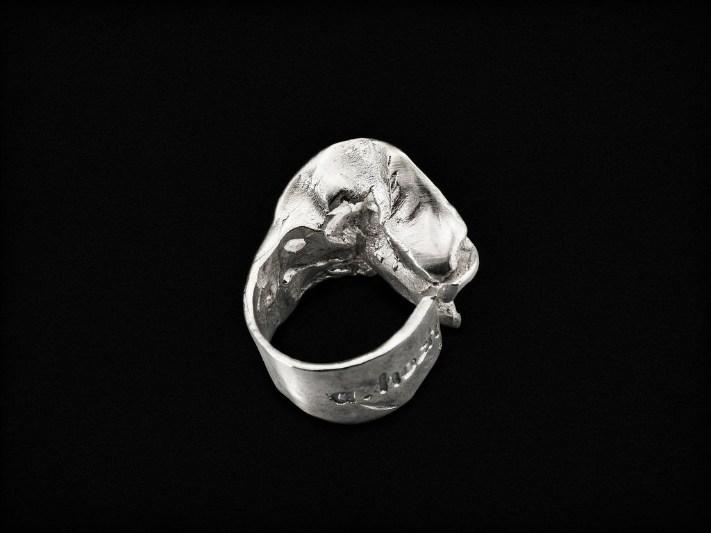Silver sculpted ring angled view with claw-like textured centerpiece