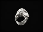 Silver sculpted ring angled view with claw-like textured centerpiece