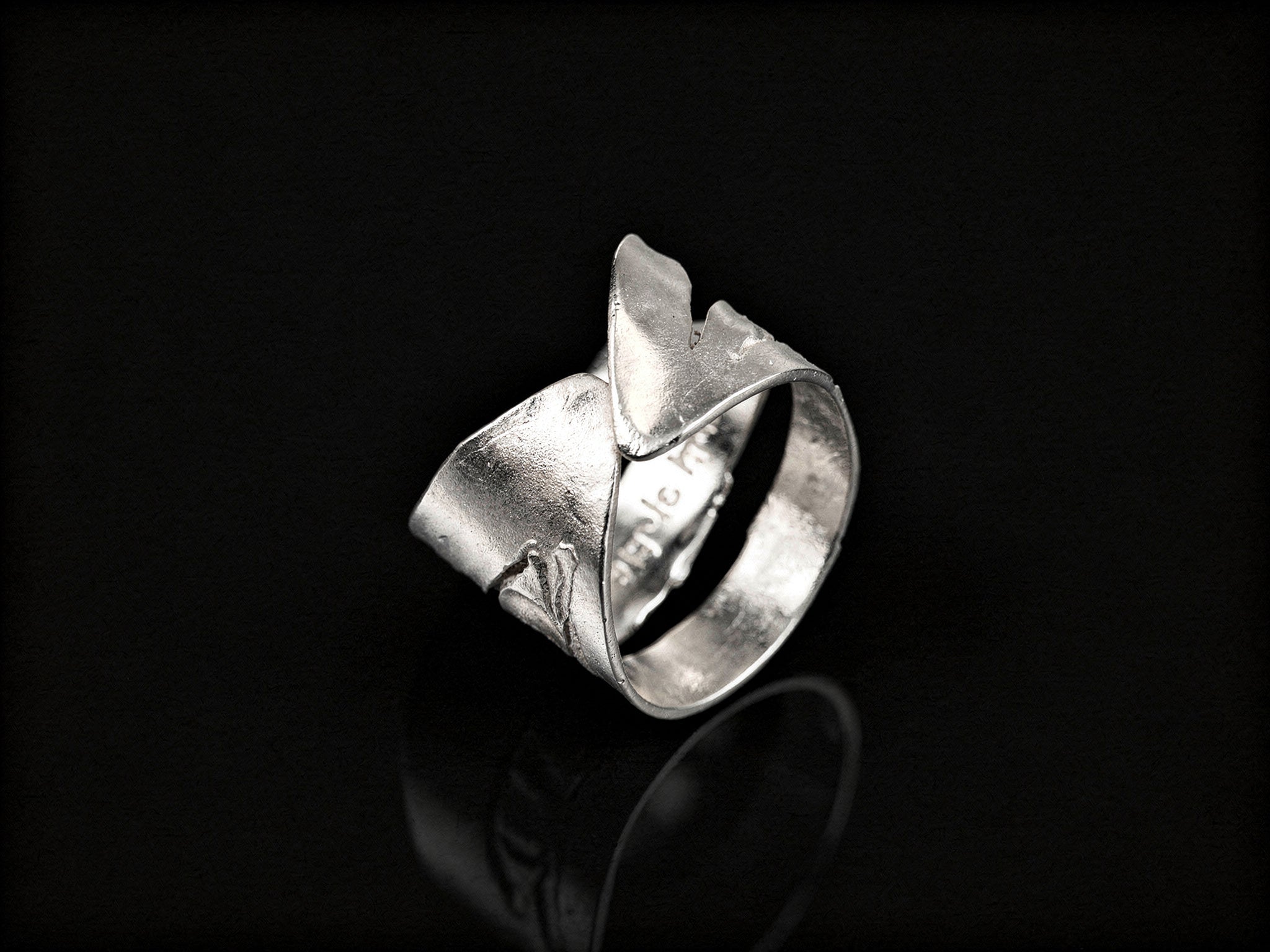 925 sterling silver ring, front view with sculpted overlapping bands and hollow cutout