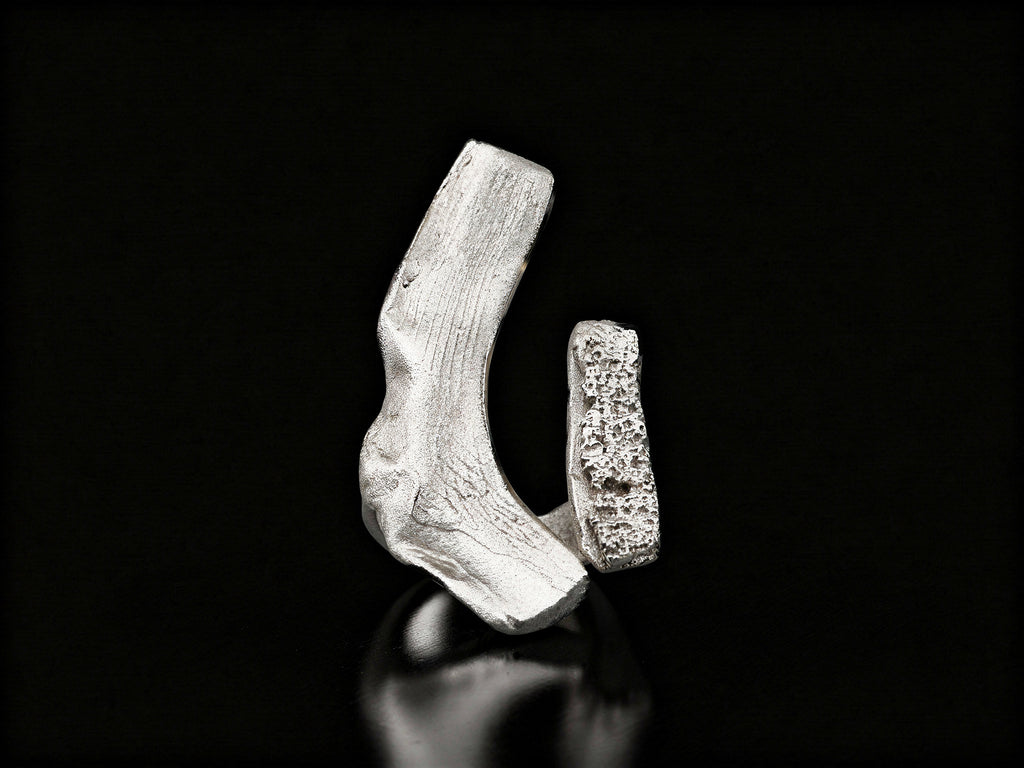 Sterling silver ring with open cuff design and rough textured centerpiece