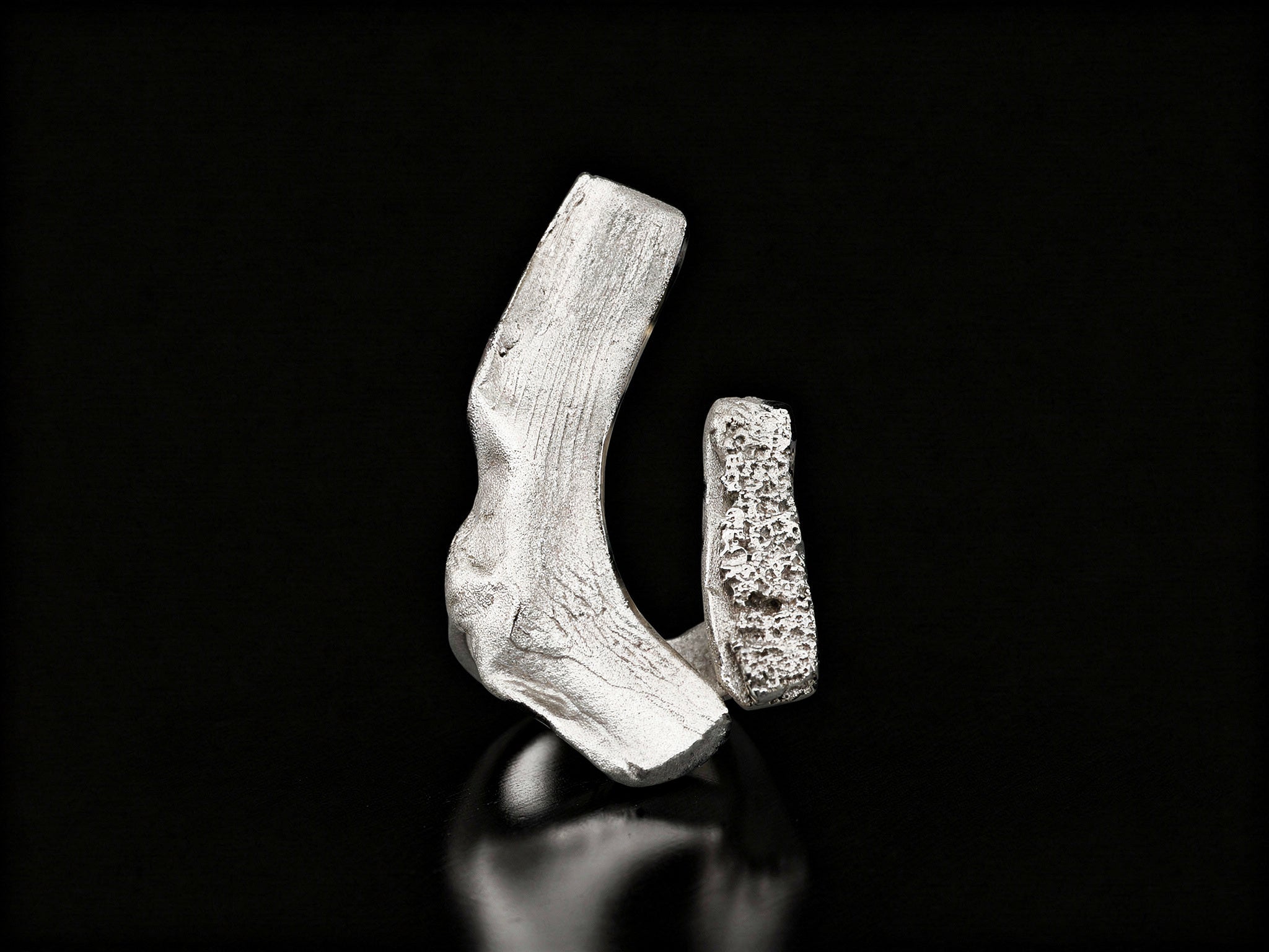 Sterling silver ring with open cuff design and rough textured centerpiece