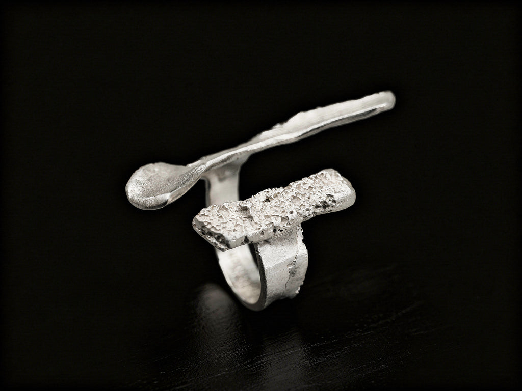 Sterling silver ring with wide abstract band and rough speckled rectangular insert