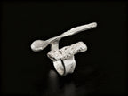 Sterling silver ring with wide abstract band and rough speckled rectangular insert
