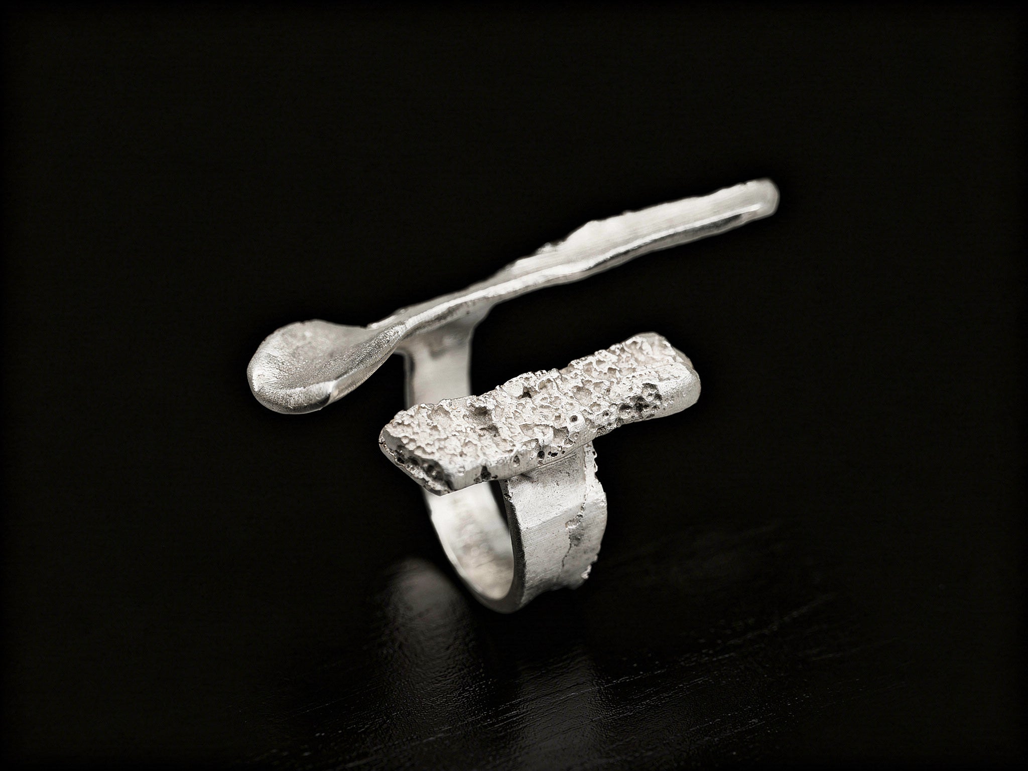 Sterling silver ring with wide abstract band and rough speckled rectangular insert