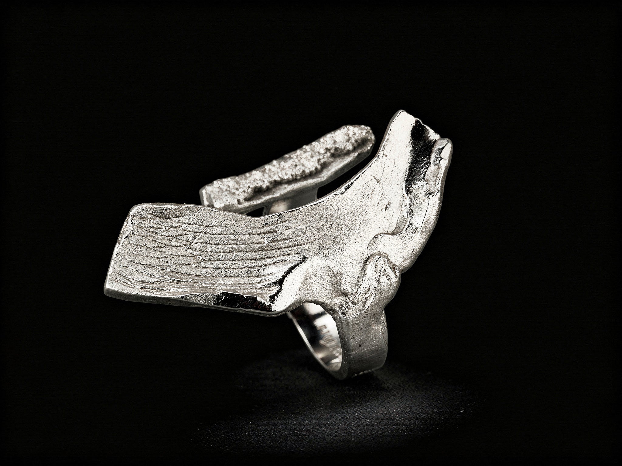 Sterling silver ring with sculpted cuff band and textured top bar detail