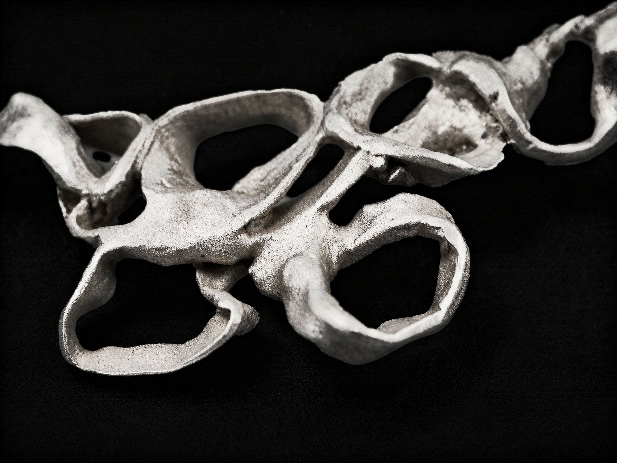 Silver abstract coral-style pendant with openwork twisted links on thin chain