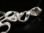 Silver coral-style pendant segment with interlocking open rings and textured surface