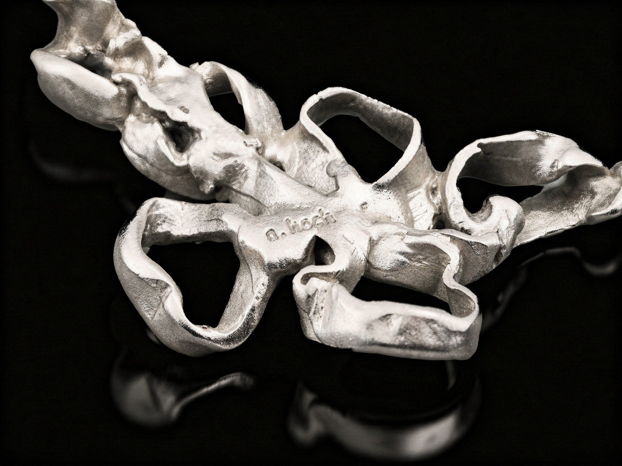 Silver coral-style pendant centerpiece with open ring loops and hammered texture