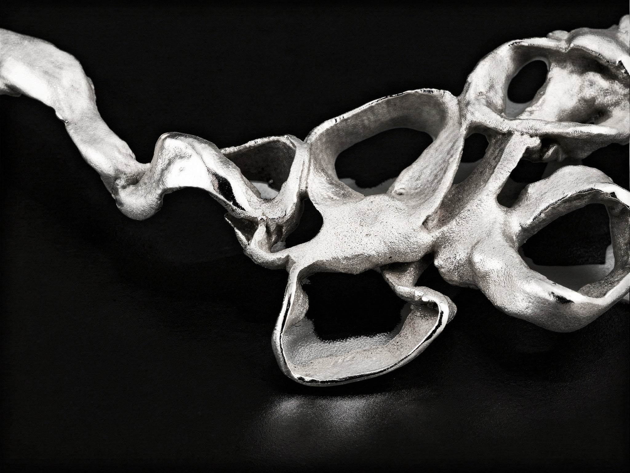 Silver coral-style pendant segment with scalloped open circles and raised texture