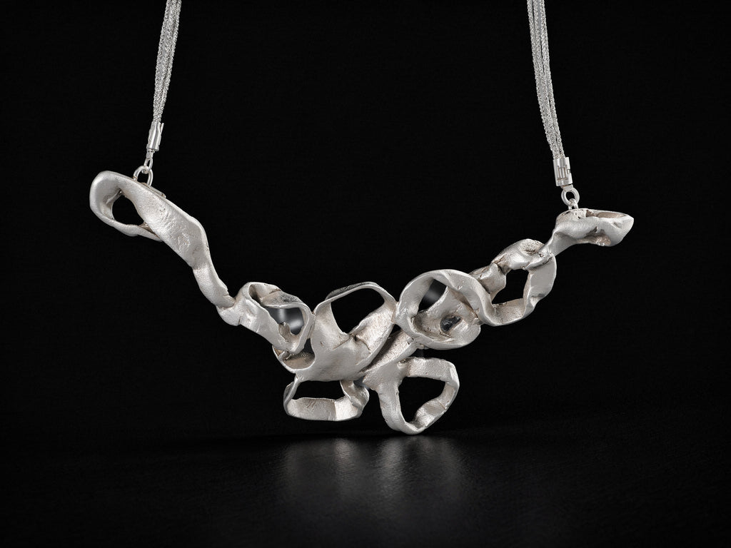 Silver coral-style pendant necklace with thin chain and openwork center links