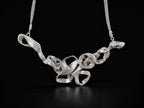 Silver coral-style pendant necklace with thin chain and openwork center links