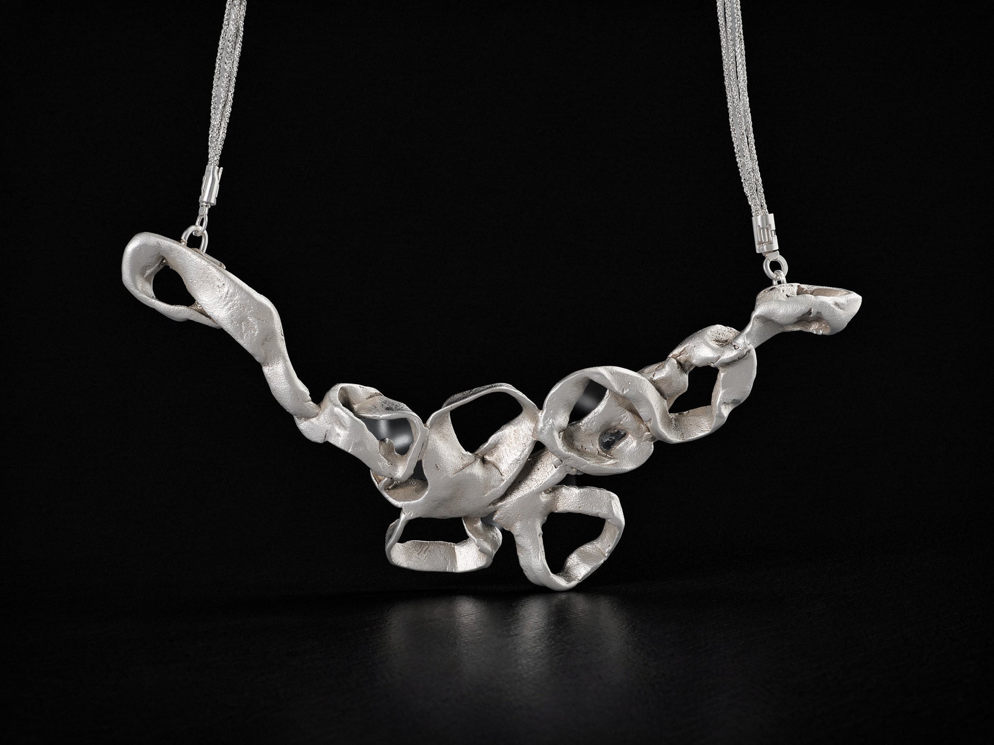 Silver coral-style pendant necklace with thin chain and openwork center links