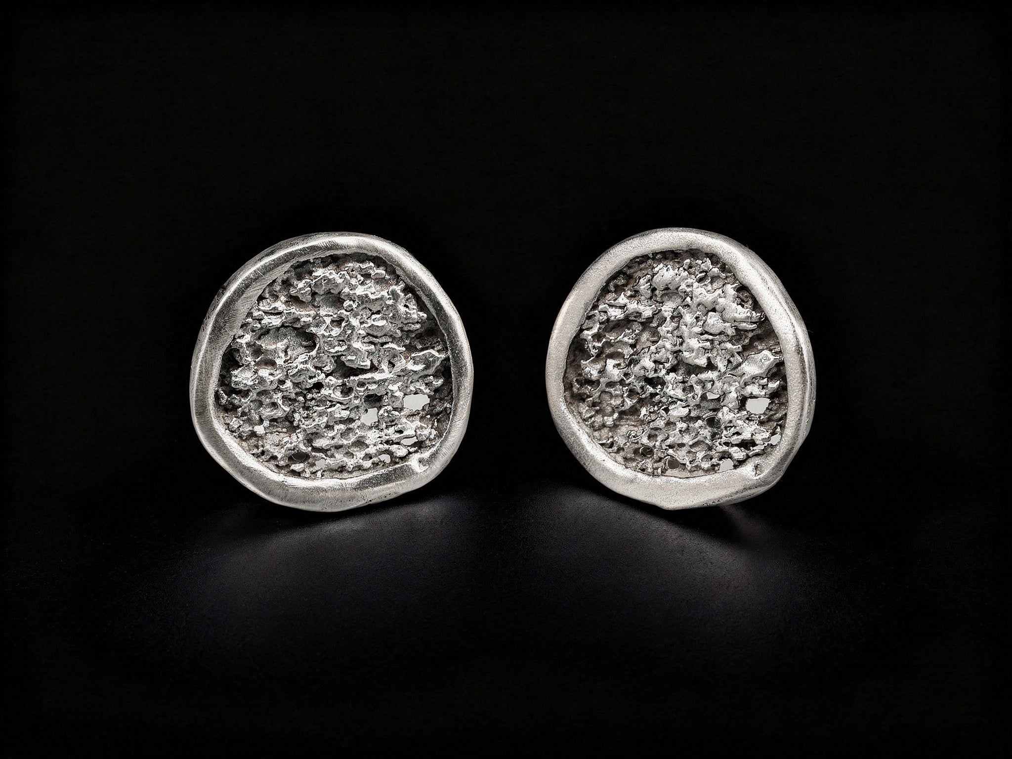 925 sterling silver oval stud earrings with textured center and polished edge