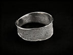 Silver textured cuff bracelet with wide band and smooth open-ended interior