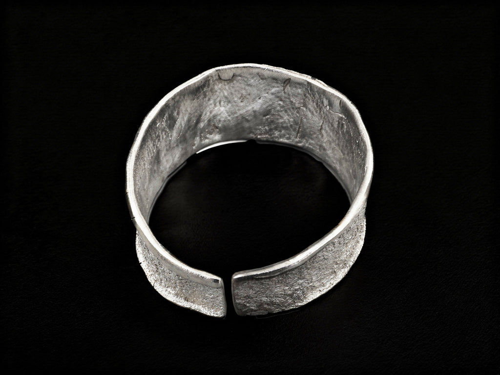 Silver wide cuff bracelet, open ends with centered flat clasp detail