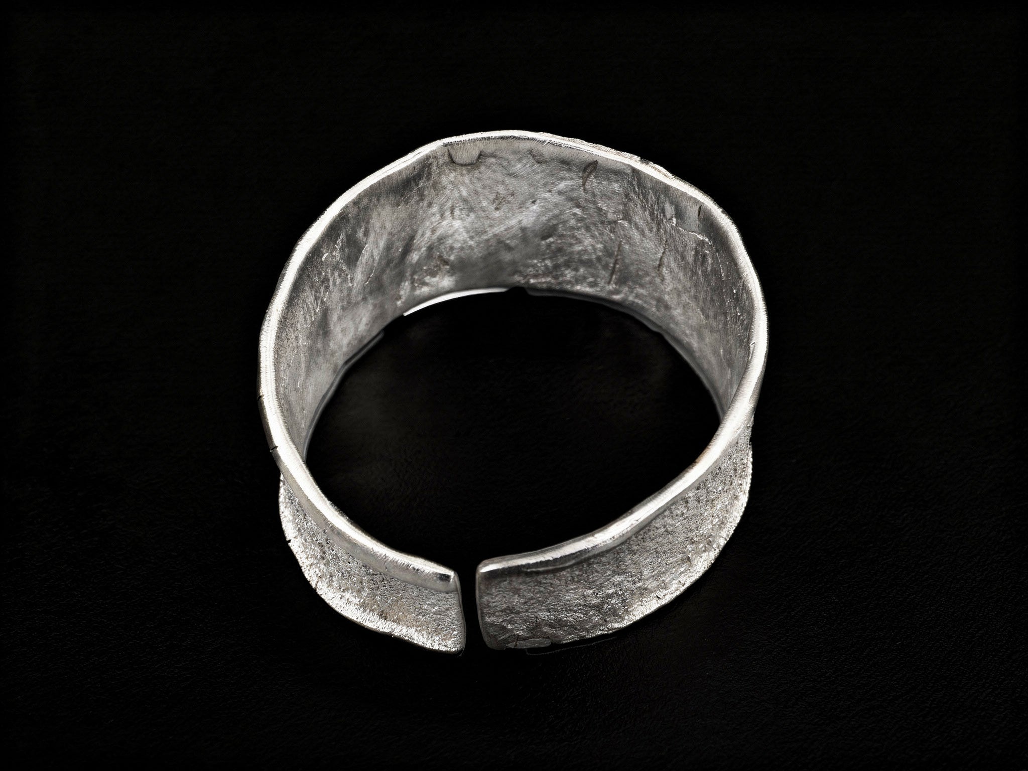 Silver wide cuff bracelet, open ends with centered flat clasp detail