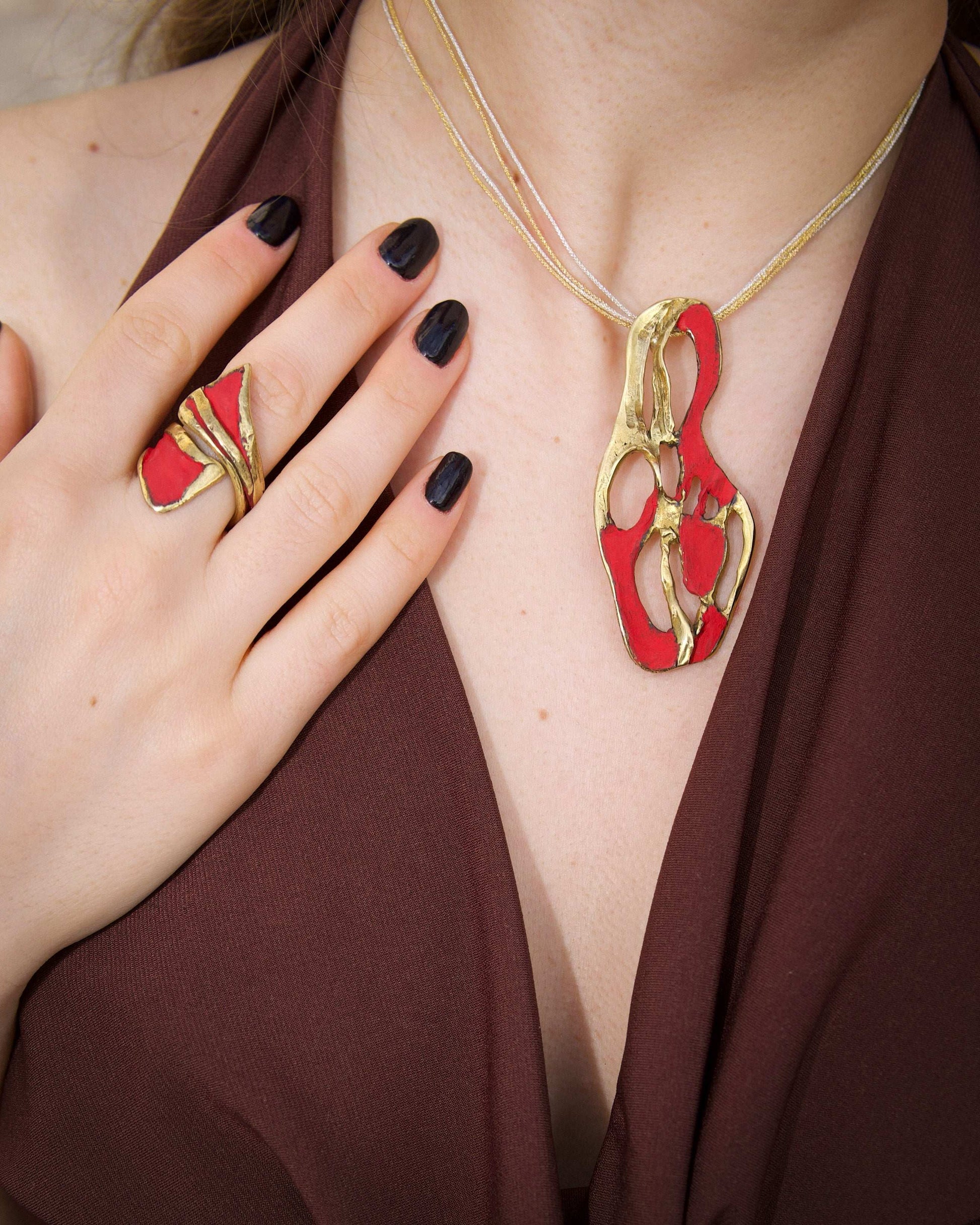 Gold dragon claw ring with red enamel and raised detailing