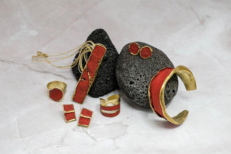 Red rectangular stone pendant necklace with gold-tone links and matching small pieces