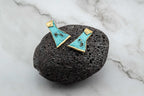 Turquoise statement earrings with gold-edged triangular cutouts, textured finish