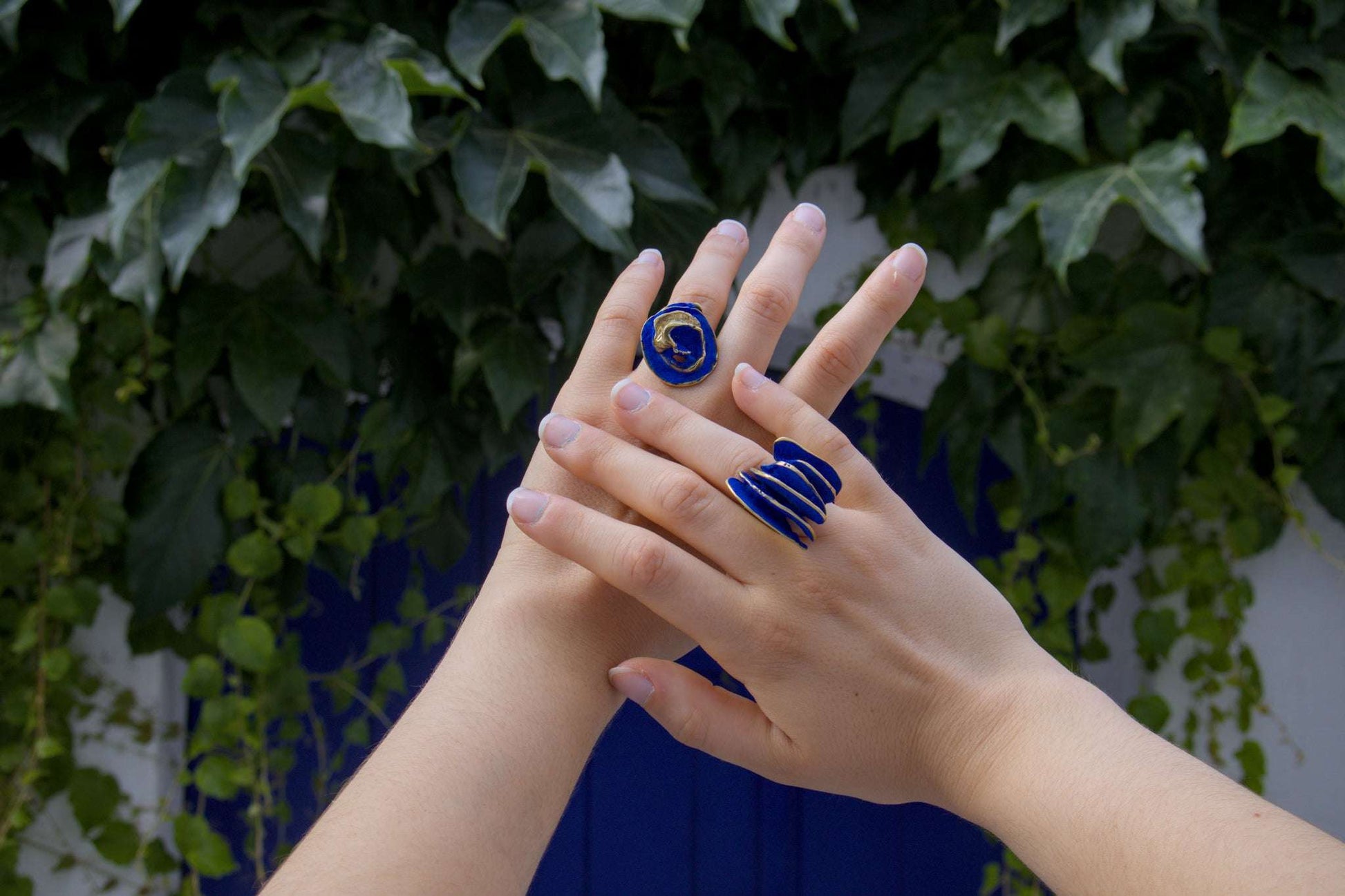 Gold-tone ring with blue spiral inlay on finger