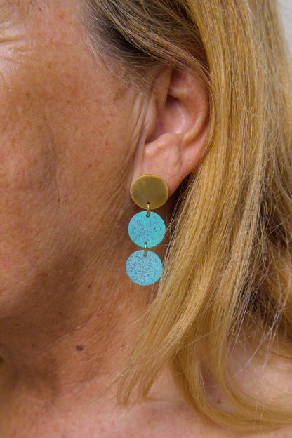 Three-disc motion earrings with gold-tone top and two stacked turquoise disc drops