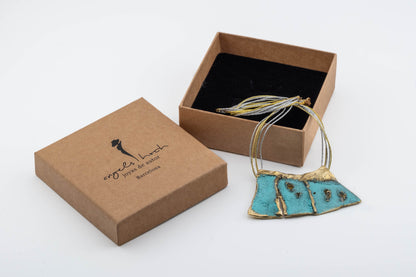 Turquoise enamel pendant necklace with gold-toned chain in presentation box