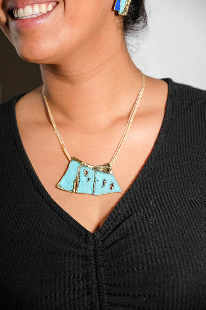 Turquoise enamel pendant necklace with geometric front on gold chain