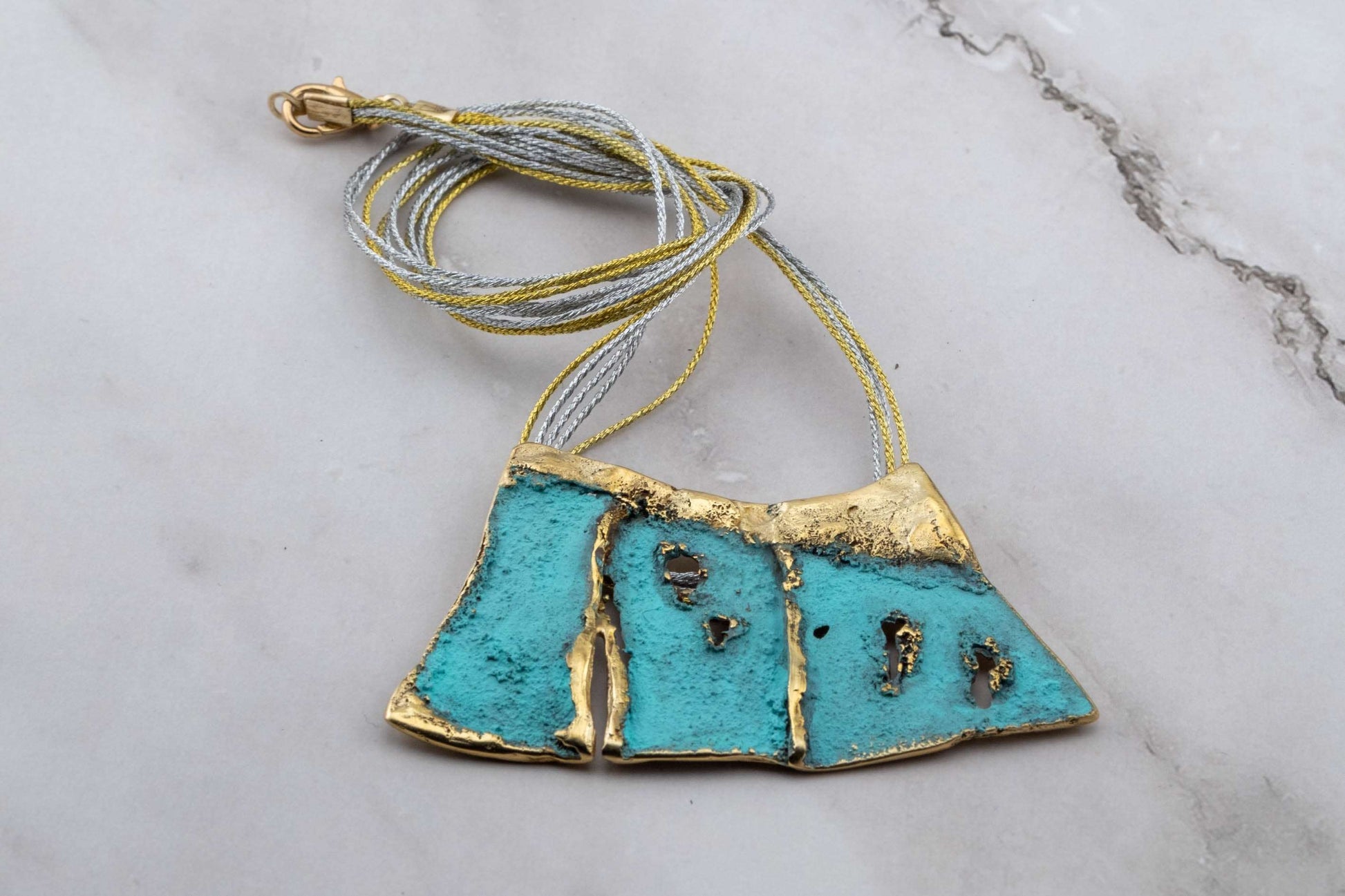 Turquoise enamel pendant necklace with blue cord and gold-toned top
