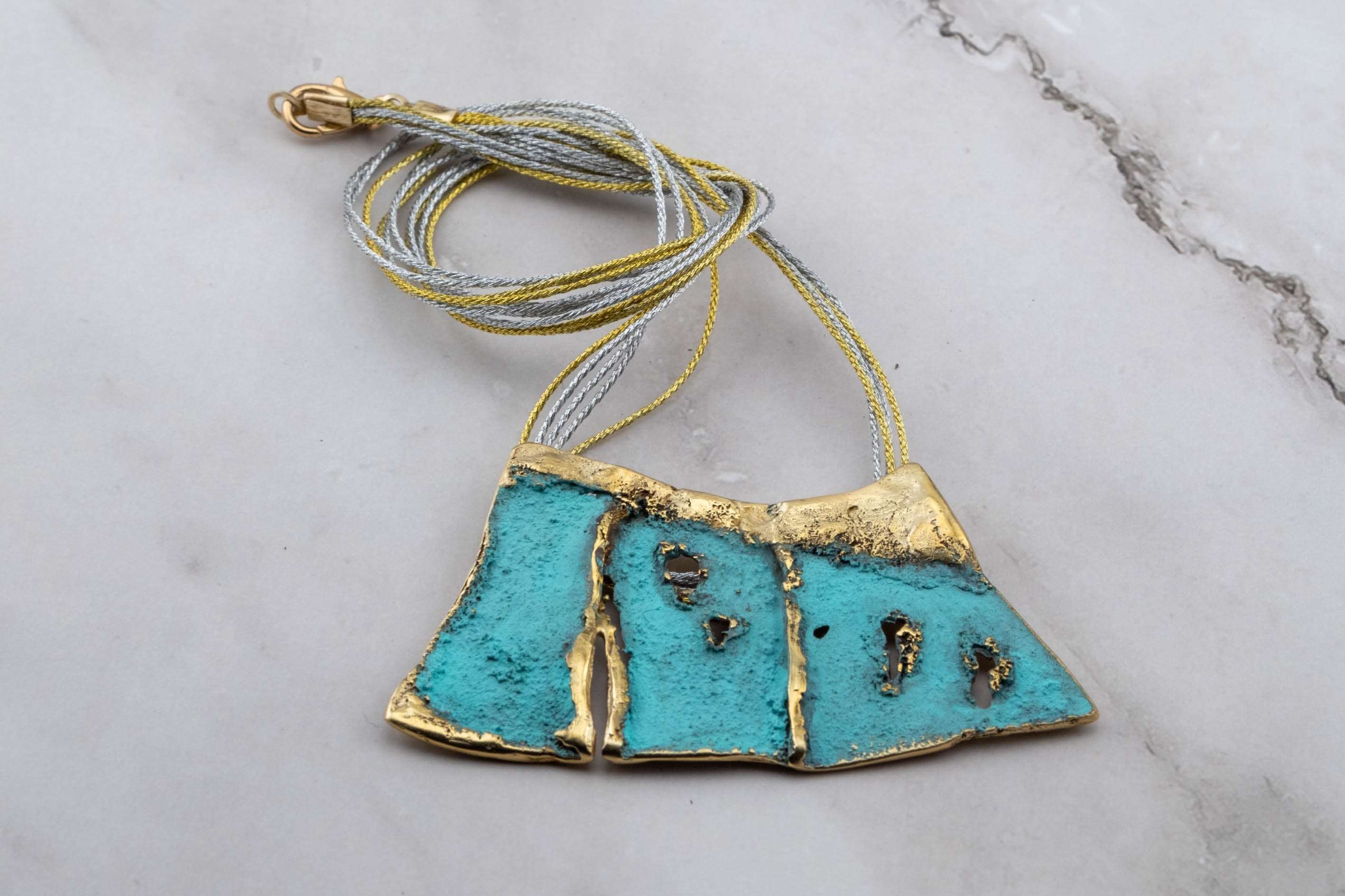 Turquoise enamel pendant necklace with blue cord and gold-toned top