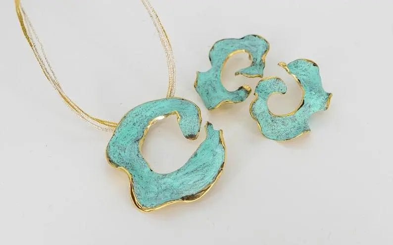 Eterna C turquoise enamel earrings with gold-tone edging, flat lay with chain and pendants