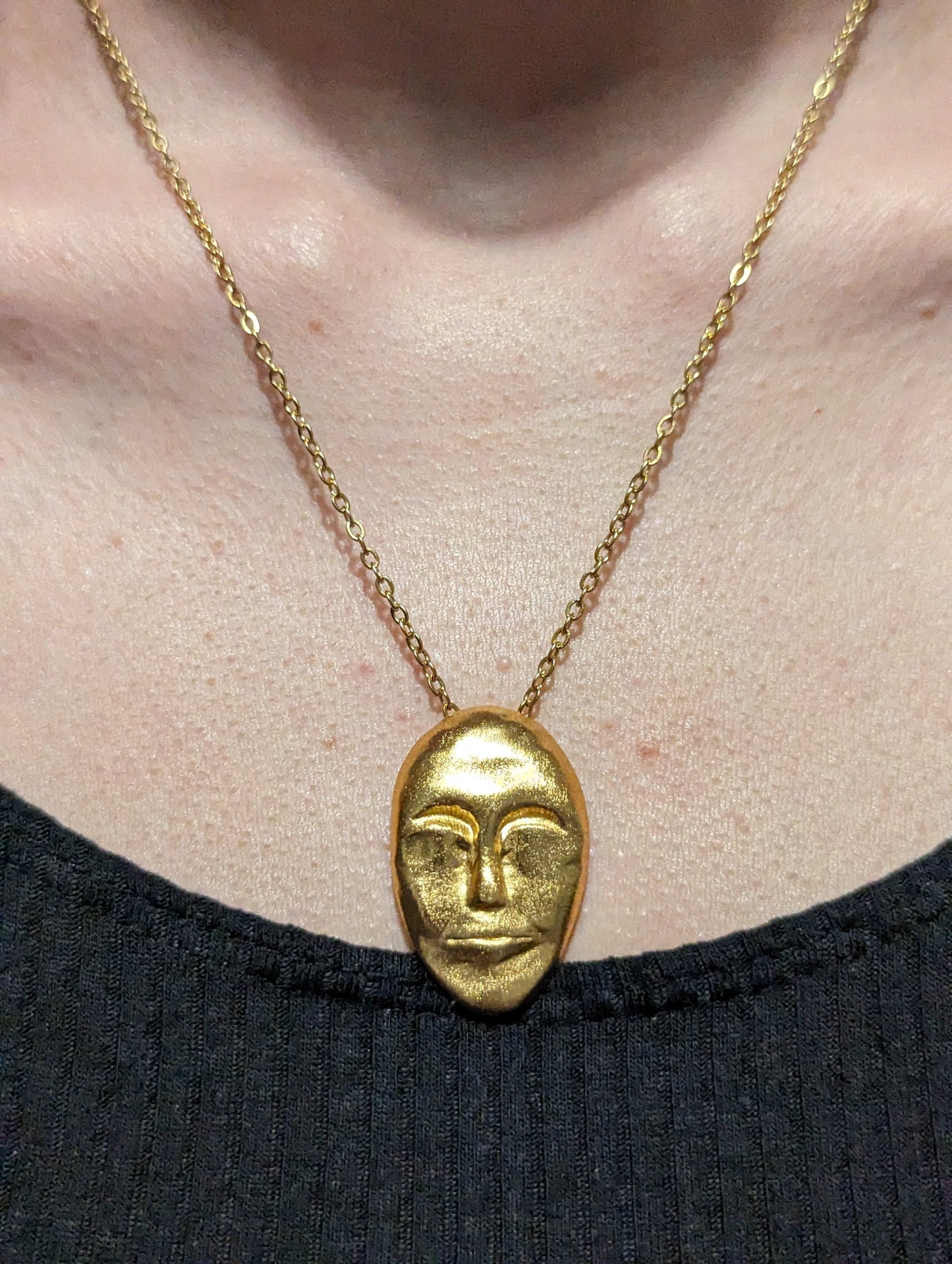 Gold face pendant necklace on chain