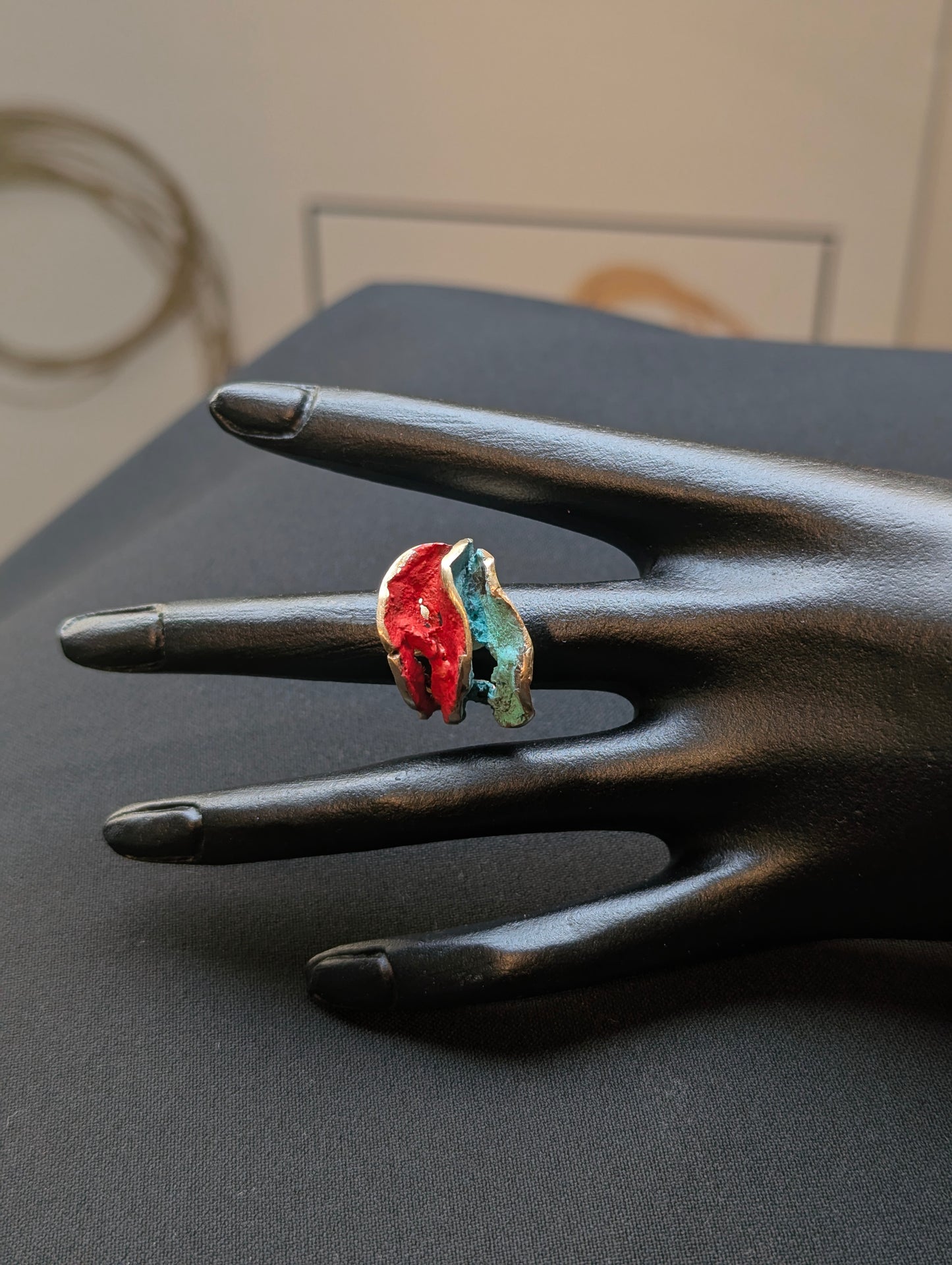 Gold-tone open ring with red and blue resin inlay on fingers