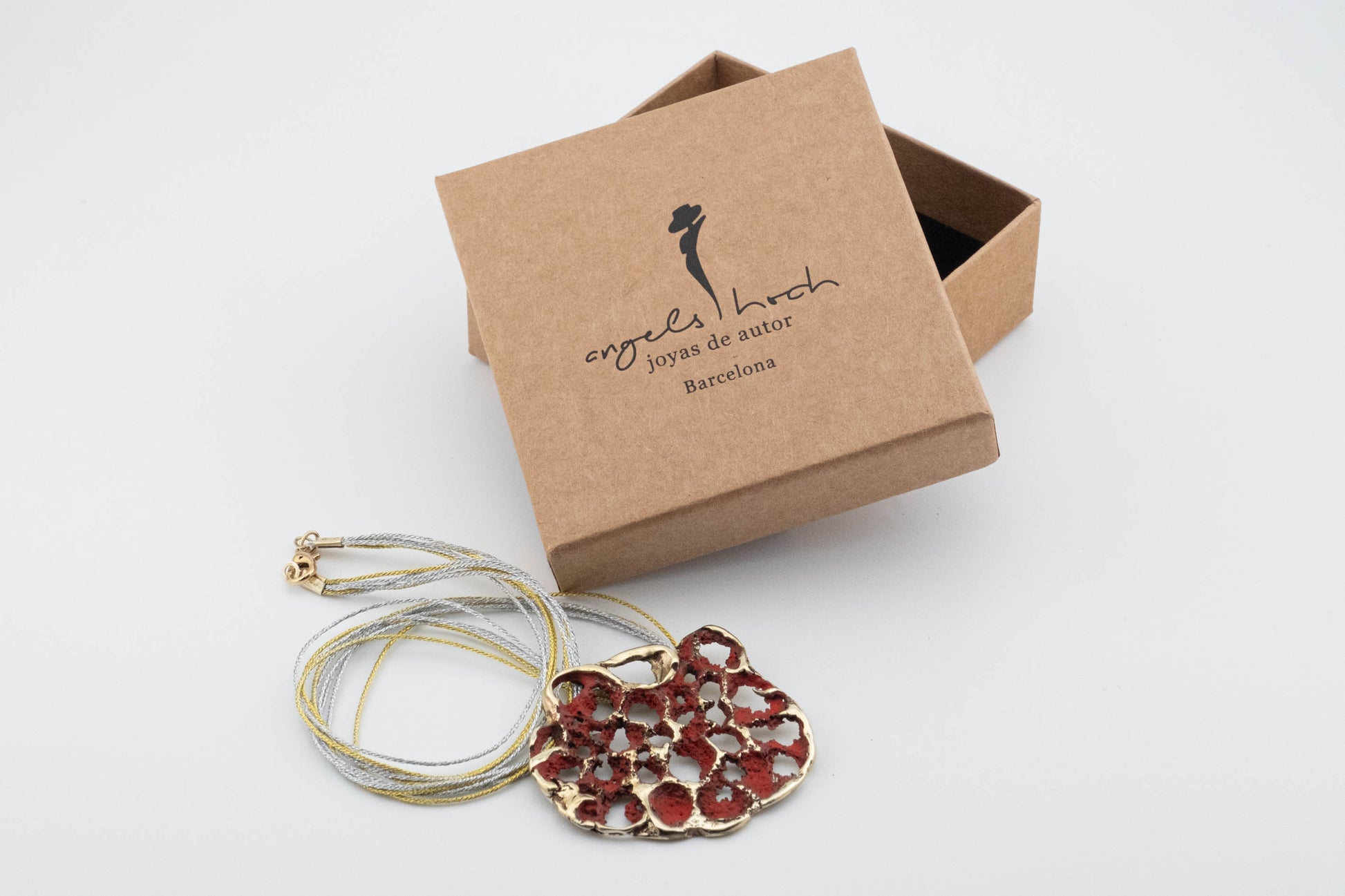 Perforata Lux pendant necklace, red perforated oval pendant with silver cord and gift box