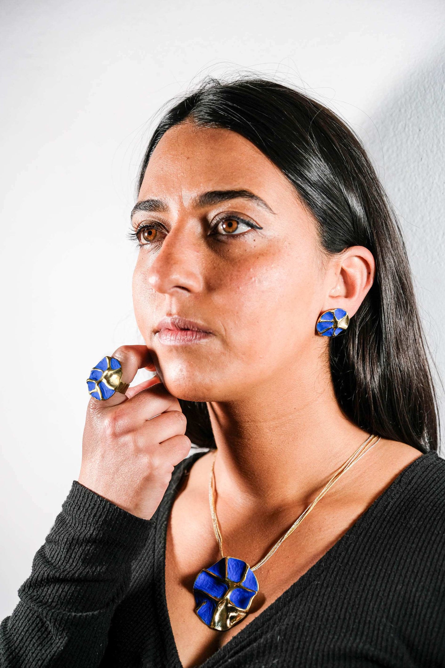 Blue and gold geometric stud earrings with bold blue stone insets