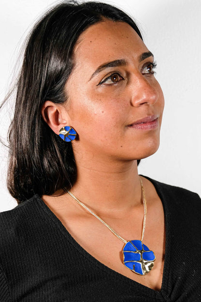 Gold-tone concept necklace with blue enamel flower pendant on thin chain