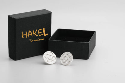 Silver round stud earrings with raised flower pattern with gift box