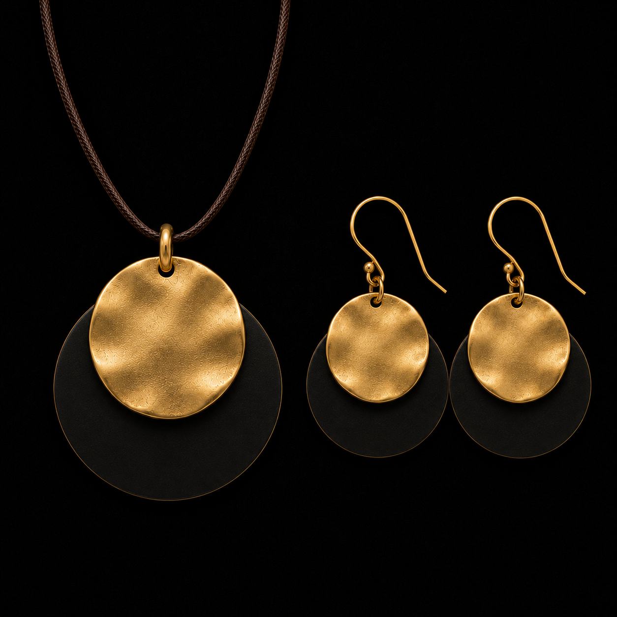 Gold-tone pendant necklace and drop earrings with gold discs and dark textured backing