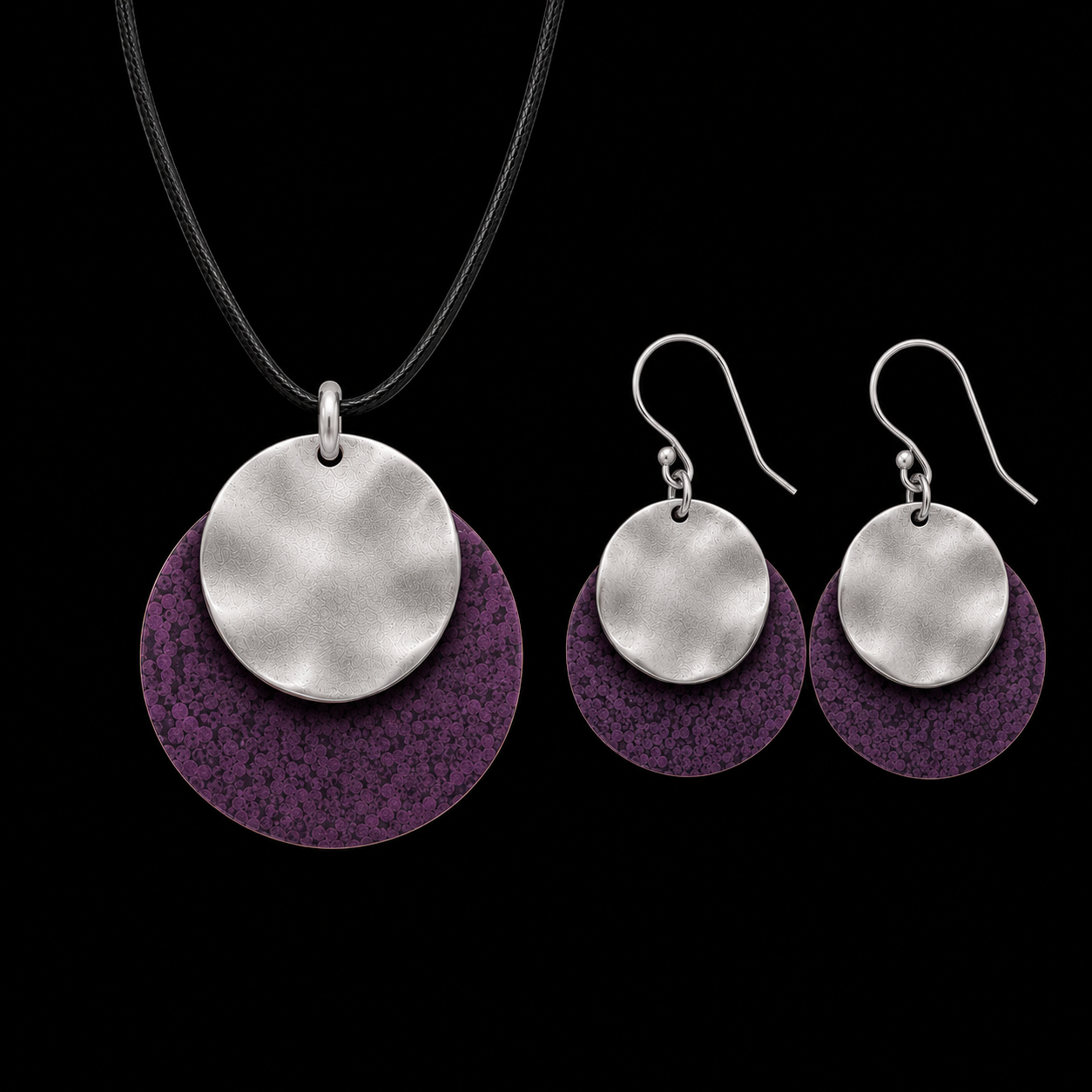 Silver-tone pendant necklace and drop earrings with large purple textured discs and black cord