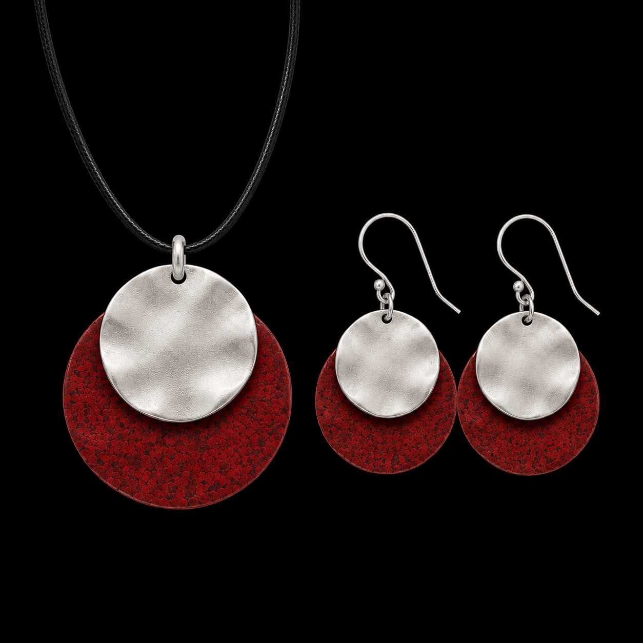 Silver-tone pendant necklace and drop earrings with silver discs and red textured backing
