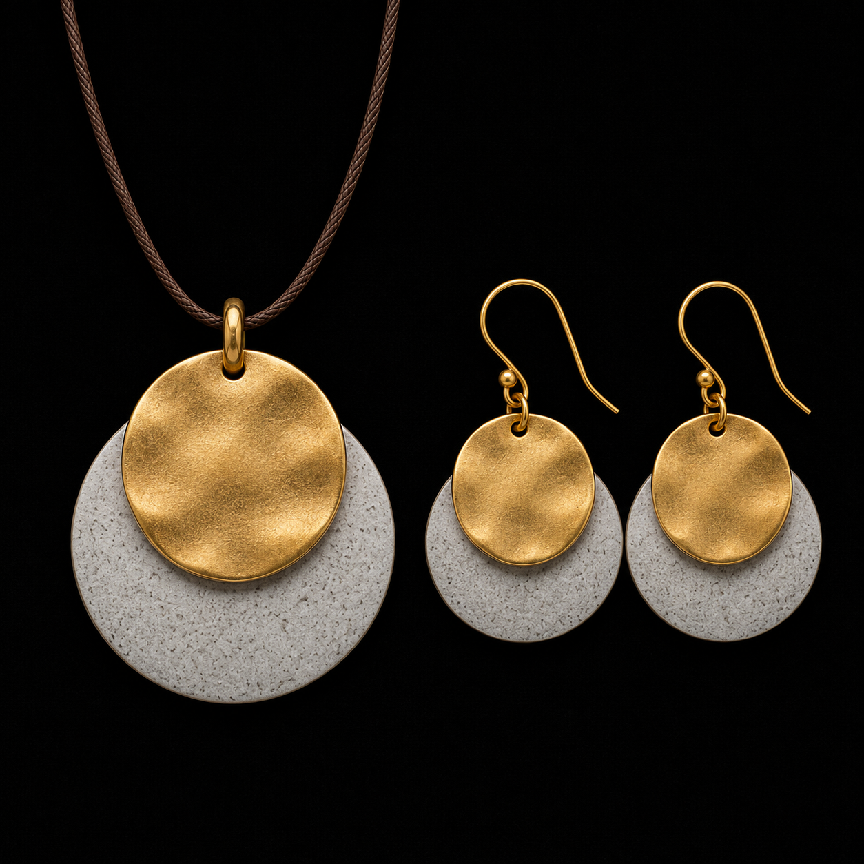 Gold-tone pendant necklace and drop earrings with gold discs and light gray textured backing