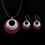 Silver-tone pendant and hoop earrings set with purple textured discs and black inner circles