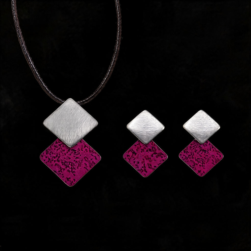 Silver-tone necklace with three stacked diamond charms: brushed silver and purple enamel