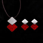 Silver-tone necklace with three stacked diamond charms: brushed silver and red enamel