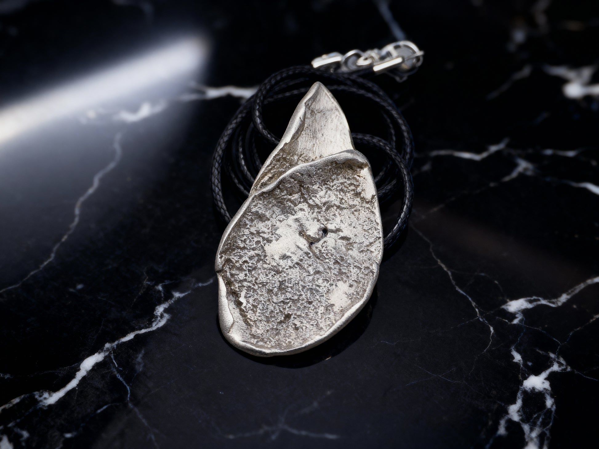 Silver-tone hammered teardrop pendant necklace with black cord
