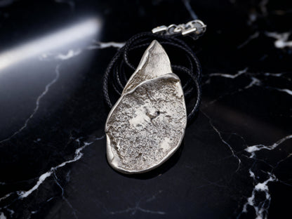 Silver-tone hammered teardrop pendant necklace with black cord